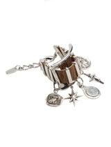 Chunky cuff bracelet featuring brown snake-print leather and dangling silver charms, showcasing an edgy, unisex design.