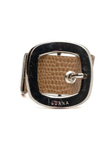 Chunky beige leather cuff bracelet featuring a prominent silver buckle and textured design, perfect for bold outfits.