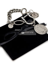 Silver-plated shackle bracelet with large coin pendants, chunky heavy-link chain, and industrial U-lock clasp.