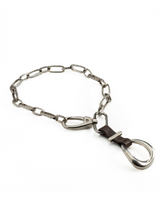 Chunky choker with a large, polished silver buckle and dark leather detail, featuring a hammered iron chain design.