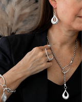 Bold open teardrop earrings in antique silver finish, hanging elegantly on a model, showcasing a hypoallergenic design.
