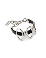 Black leather cuff bracelet featuring shiny oval metal elements, adjustable chain, and a secure clasp for a stylish fit.