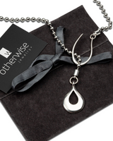 Classy stainless steel ball chain necklace featuring a teardrop zamak pendant, displayed with a suede gift pouch.