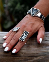 Bracelet with triangular grey-black Austrian crystal on a wrist, paired with a matching chunky ring.