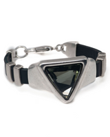 Adjustable bracelet featuring a large grey-black triangular Austrian crystal set in silver-toned Zamak metal.