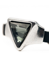Adjustable bracelet featuring a large grey-black triangular Austrian crystal set in silver-toned metal with a black leather band.
