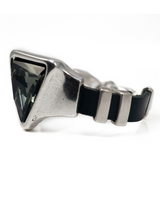 Adjustable bracelet featuring a bold grey-black triangular Austrian crystal set in silver-toned Zamak metal with a black leather band.