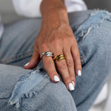 Minimalist 925 Sterling Silver rings in silver and gold plating, worn stacked on fingers showcasing clean lines.