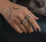 Irregular wrap minimalist 925 sterling silver ring, worn on the finger with an adjustable, sleek design and malleable finish.