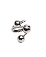 Adjustable stainless steel ring featuring three shiny spheres in a modern wrap-around design, perfect for statement wear.