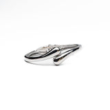 Chunky silver cuff bangle with a sleek, polished finish, featuring a minimalistic design suitable for stacking.