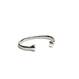 Silver plated open bangle cuff with rounded ends, featuring a sleek design and polished finish.