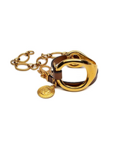 Gold triple wrap bracelet featuring a light brown leather strap and a stainless steel chain with a metal hoop detail.