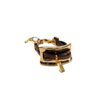 Chunky gold metal plate bracelet with intertwined brown leather strips; adjustable with a chic chain detail.
