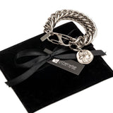 Chunky stainless steel chain bracelet featuring a double lobster clasp and an ancient Greek coin pendant in silver.