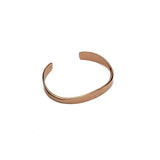 Minimalist rose gold cuff bracelet with a smooth, flexible design, adjustable to fit various wrist sizes.
