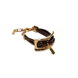 Brown leather strips intertwine around a large gold metal plate in this unisex statement bracelet. Adjustable fit.