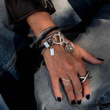 Double wrap bracelet with multiple snake chains, leather and unique buckle with coin pendant for a statement look