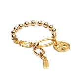 Chic gold bracelet featuring a ball chain and a Greek coin, with a stylish and polished finish.