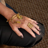 Chic gold bracelet with ball chain and Greek coin, featuring a 24K gold-plated brass design, presented on a model's wrist.