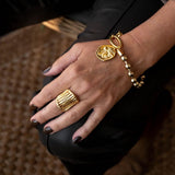 Chic gold bracelet with ball chain and Greek coin, featuring a 24K gold-plated brass design and textured clasp.