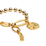 Chic gold bracelet with ball chain and Greek coin, featuring a shiny gold-plated brass design and textured coin charm.