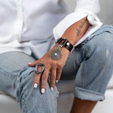 Textured brown leather horsebit bracelet with white opal Swarovski crystal pendant and silver-tone chain