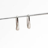 High polished silver teardrop earrings, measuring 2 inches, showcasing a sleek and elegant design.