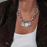 Silver safety pin box chain necklace with chunky curb chain and coin pendants in a rock style choker design