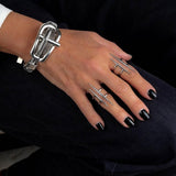 Stainless Steel Double Bar Ring with irregular bars, worn on a hand with black nail polish, alongside a silver bracelet.
