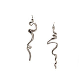 Mismatched asymmetrical earrings with irregular, abstract designs in shiny silver. Each earring has a unique shape.