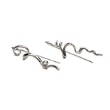 Mismatched asymmetrical earrings with abstract, irregular designs in shiny silver, measuring 2.5 inches in length.