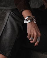 Chunky khaki leather double-wrap bracelet with a large decorative silver-plated western buckle and adjustable fit.