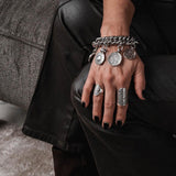 Chunky chain bracelet with vintage coins in silver-plated metal, featuring a soft leather closure for comfortable wear.