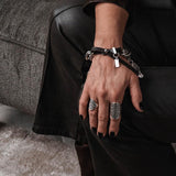 Chunky chain bracelet with vintage coins and leather closure, featuring silver-plated links and a comfortable leather strap.