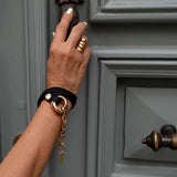 Chunky double link bracelet in honey gold and black leather, featuring soft stitched leather and stainless steel chain.