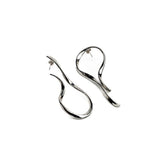 Large asymmetric dangle earrings feature a polished silver-tone metal design with irregular lines and textured hammered studs.