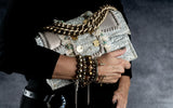 Bronze Hematite Bracelet features a dense metallic finish, worn stacked with other bracelets, showcasing an edgy style.