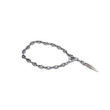 Stainless steel ankle bracelet with a flat oval link design and pointed charm, offering a stylish layered look.