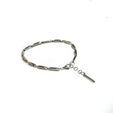 Silver stainless steel anklet featuring a faceted bar link design with an adjustable chain for a layered look.