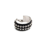 Bold silver bangle with black leather and stud chain, wide statement cuff