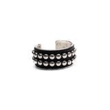 Bold silver bangle with black leather and stud chain, wide statement cuff
