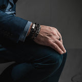 Men’s bracelet featuring strong silver-plated and leather elements on dark brown PU leather, styled for a casual look.