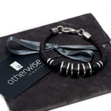 Men’s bracelet featuring strong silver-plated and leather elements on dark brown PU leather, with adjustable length.