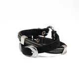 Unisex wrap bracelet featuring black leather, iron chains, and metal elements, adjustable with a buckle.