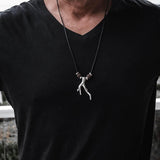 Men's adjustable black cord necklace featuring a silver wishbone pendant and brown lava stone beads.