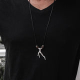 Men's adjustable black cord necklace featuring a metal wishbone pendant and brown lava stones, styled casually.