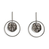 Contemporary statement earrings featuring a large circular design with a Greek coin pendant in a silver-tone finish.