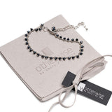 Silver anklet chain featuring faceted cut glass beads in silver night color, displayed on a suede pouch with a tag.