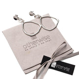 Elegant hammered triangle earrings with a long, edgy hoop dangle design on a soft suede pouch. Silver, geometric style.